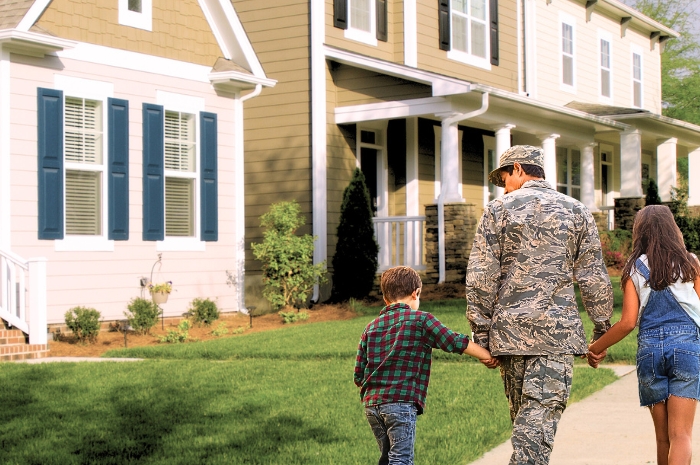 soldier walking in a neighborhood with son and daughter