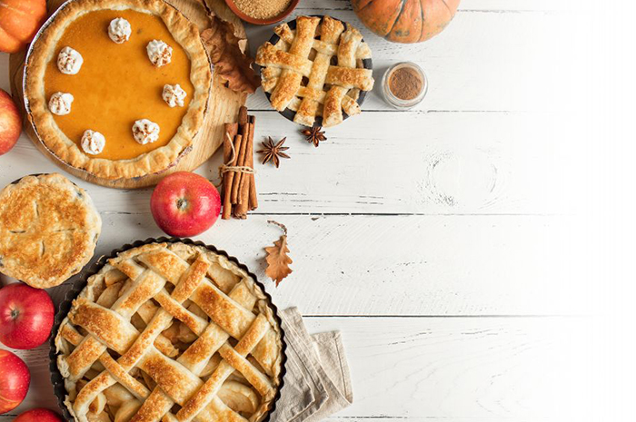 pies on a table with Fall decorations surrounding