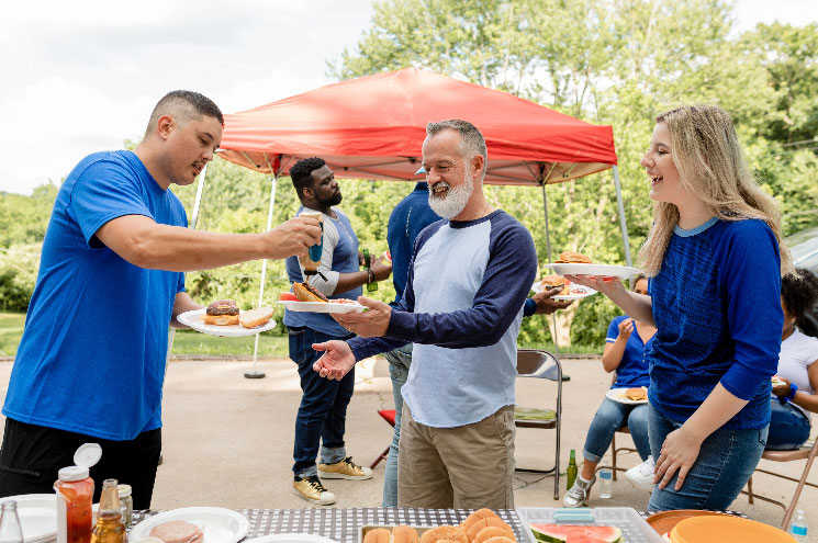 group of people attending a tailgate picnic