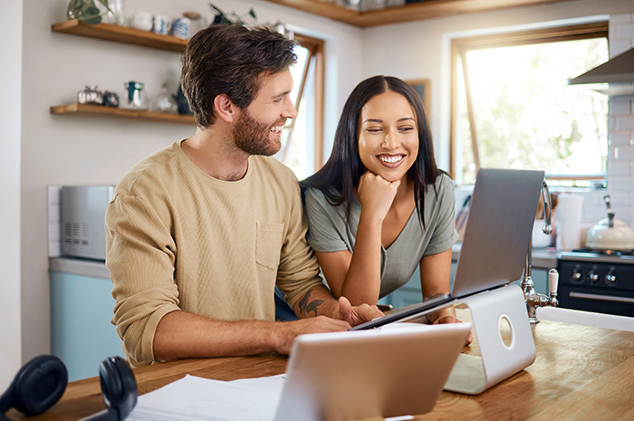 young couple looking at a laptop screen