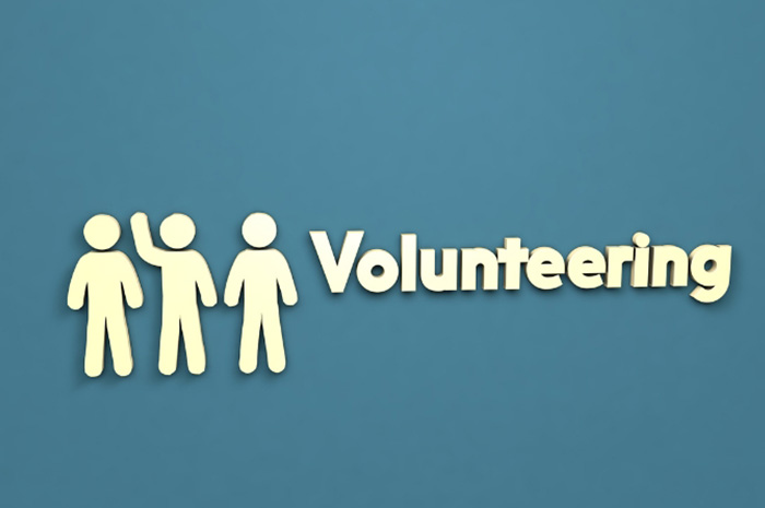 icon of volunteers next to the word Volunteering