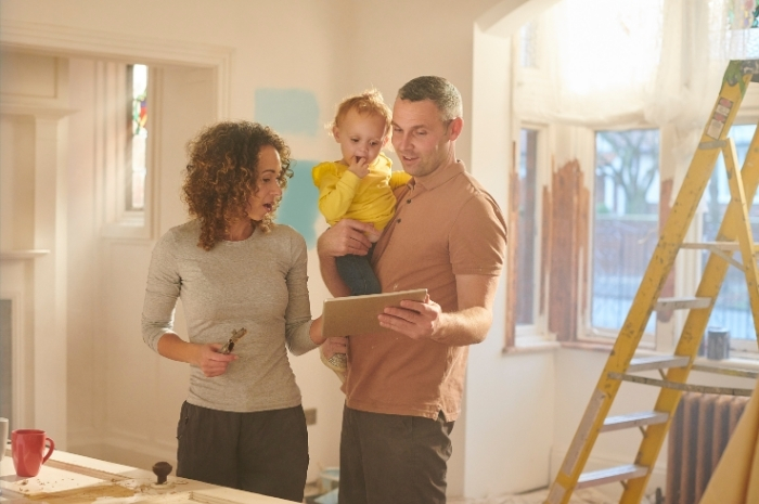 husband and wife look over remodeling plans