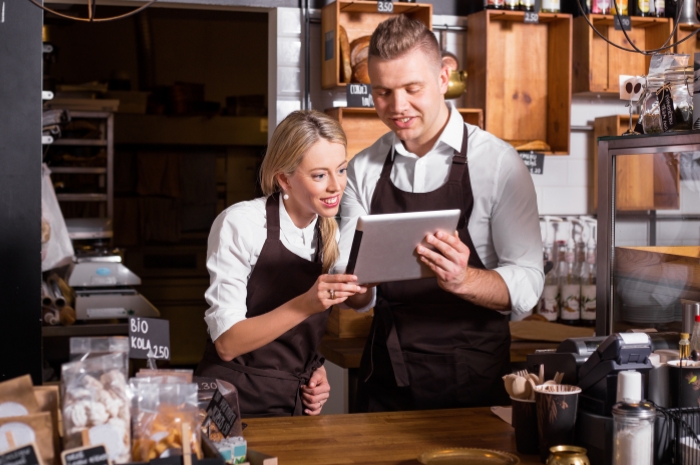 Personal Loan Application Business owners look at a tablet